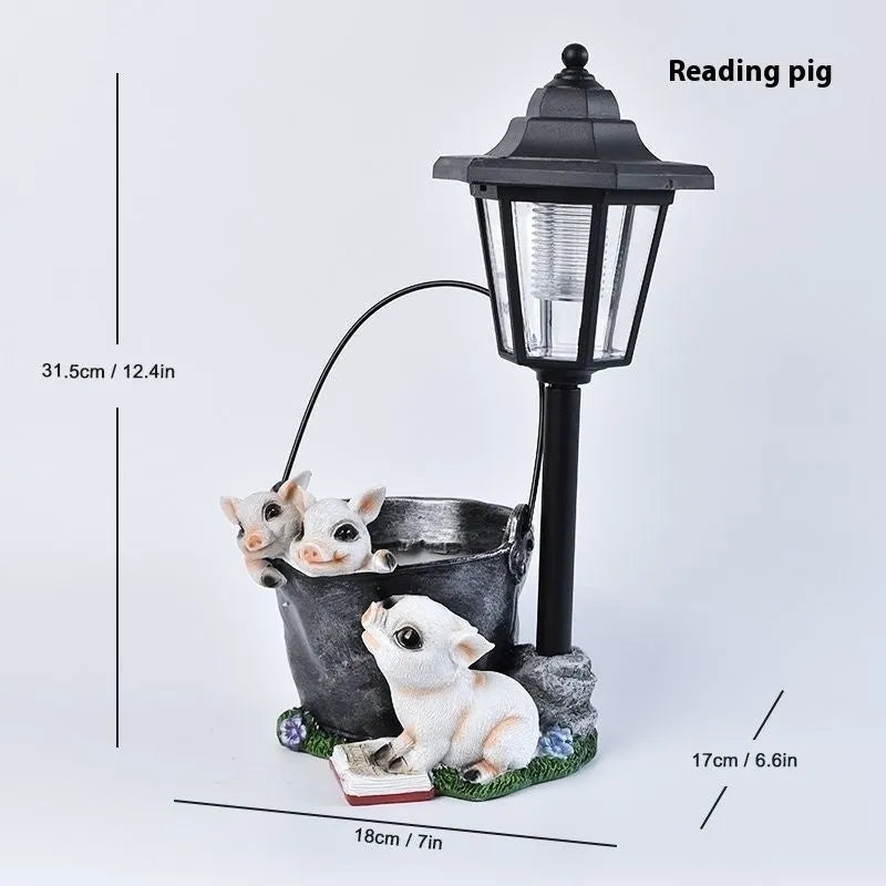 Solar hexagonal garden lamp with decorative resin figurine on plastic base for outdoor pathway lighting