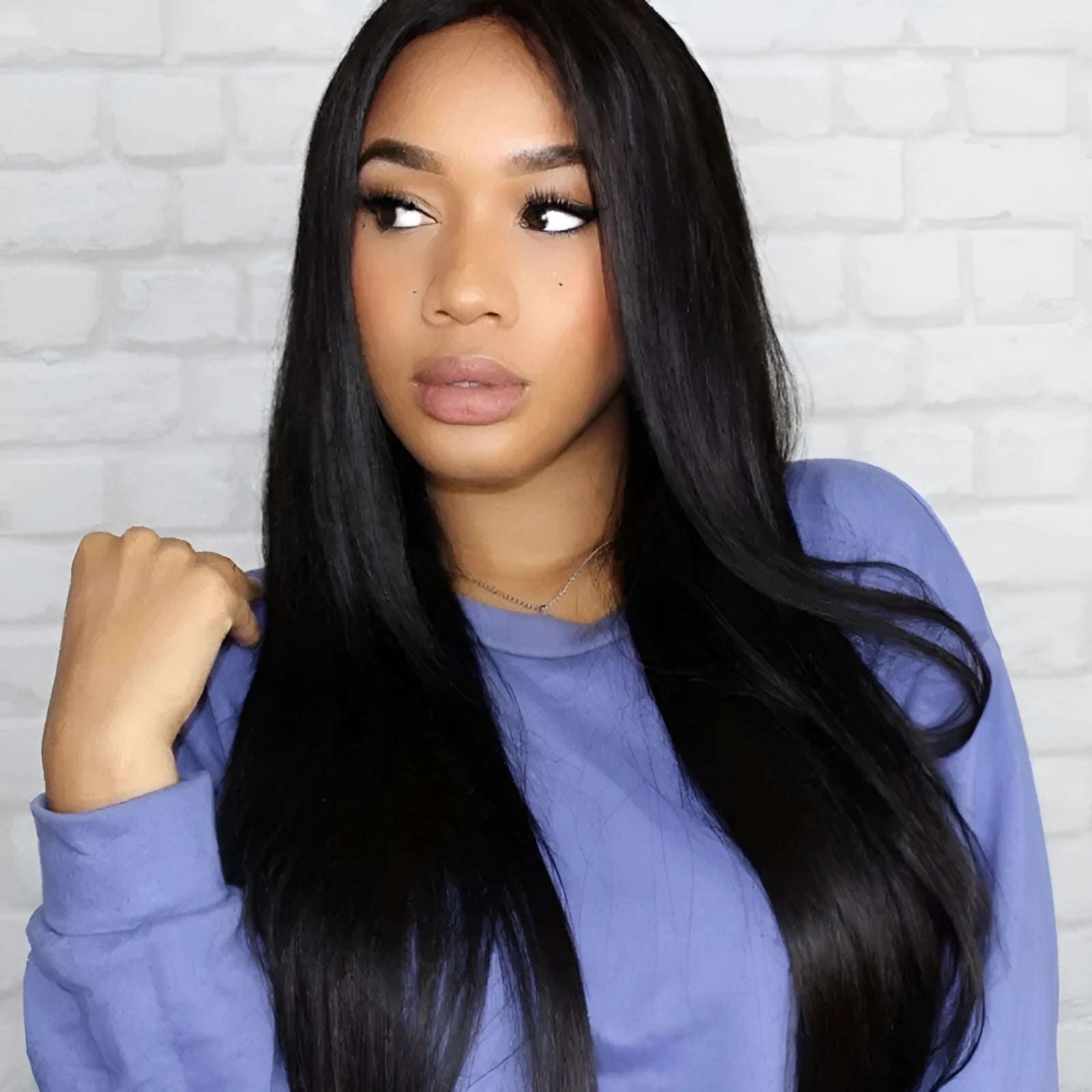 Long straight black synthetic wig with centre-parted bangs on a model.