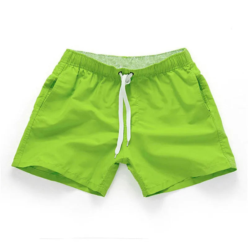 Men's straight-leg beach shorts in polyester, shown in a colour from the range including fluorescent yellow, black, or navy.