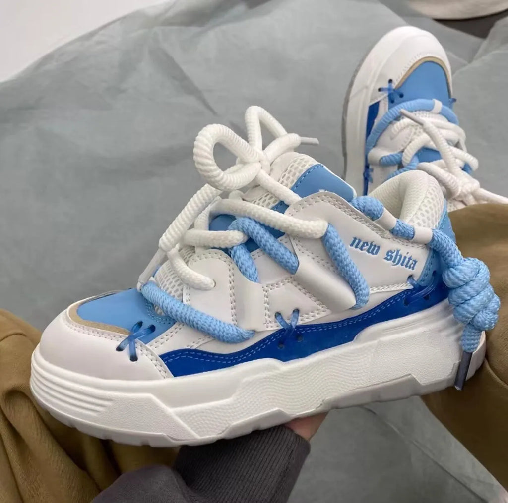 Grey retro clunky sneakers with thick rubber sole and lace-up front, shown on a white background.