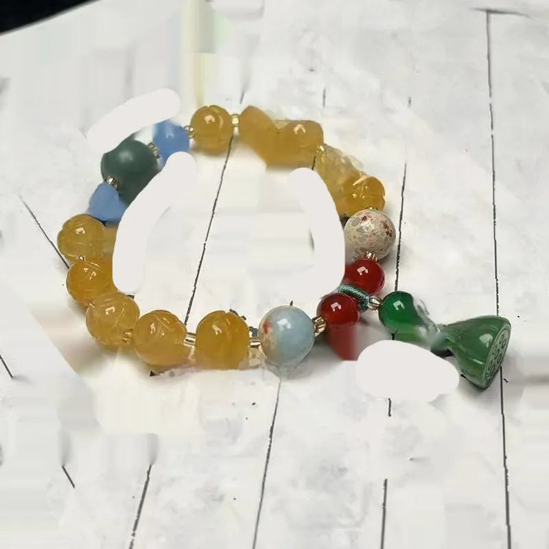 Carved pumpkin and lotus bead bracelet made from Bodhi root with white jade and aventurine details.