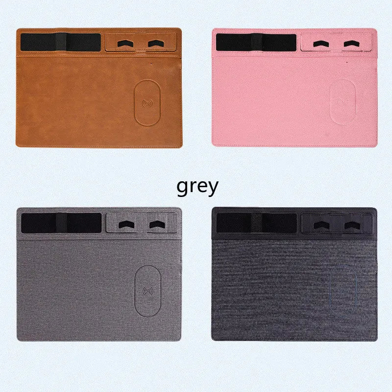 Pink PU leather wireless charging mouse pad with phone holder on a desk, showing USB cable.