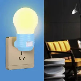 Plug-in bedside baby night light in white shell with modern round design on a table.