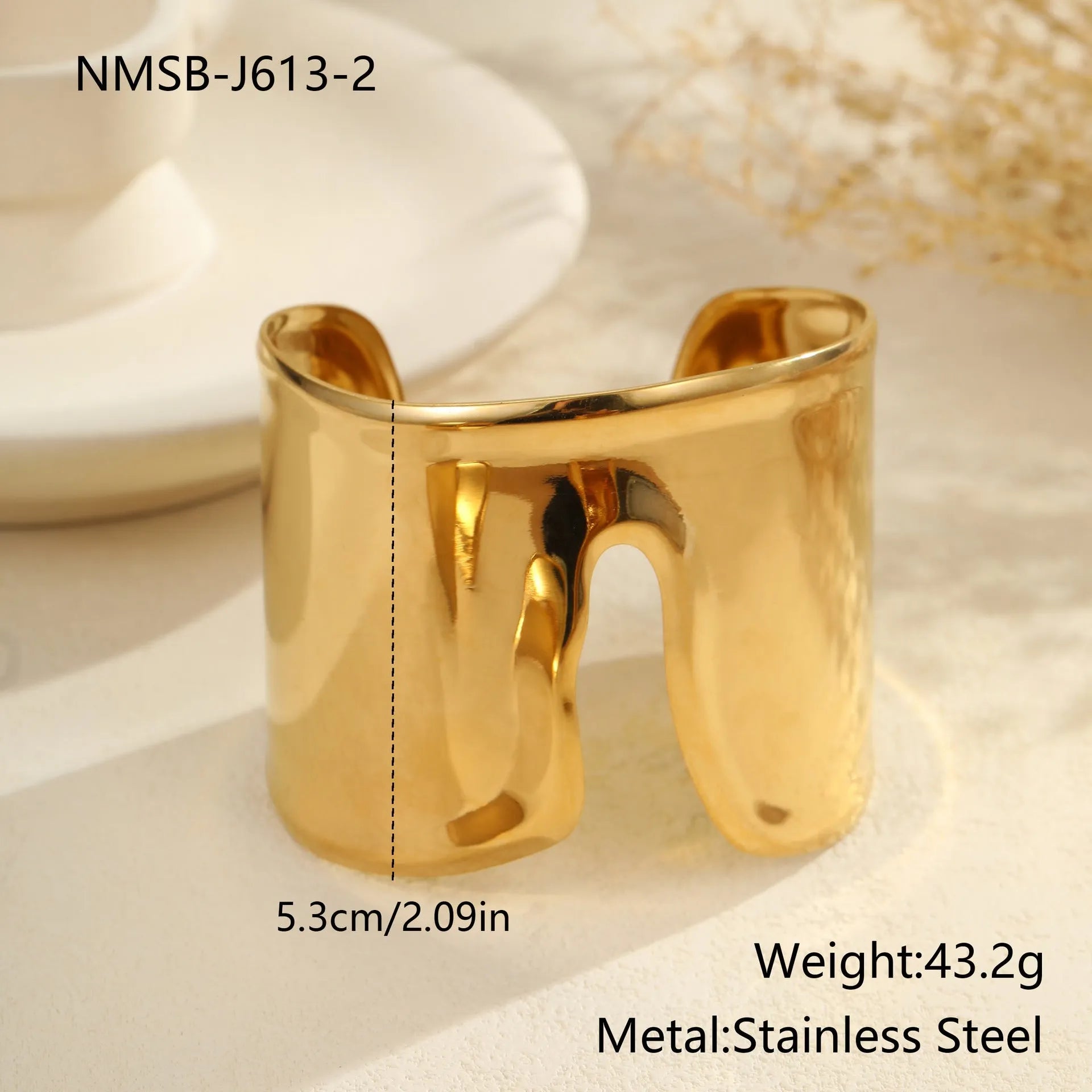 Women's wide stainless steel bracelet with 18K gold plating, geometric wave design, and niche opening closure.