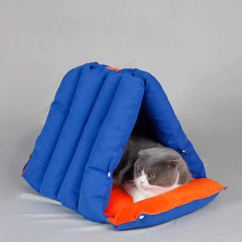 Triangular cat bed with blue removable cotton cover showing combination holes