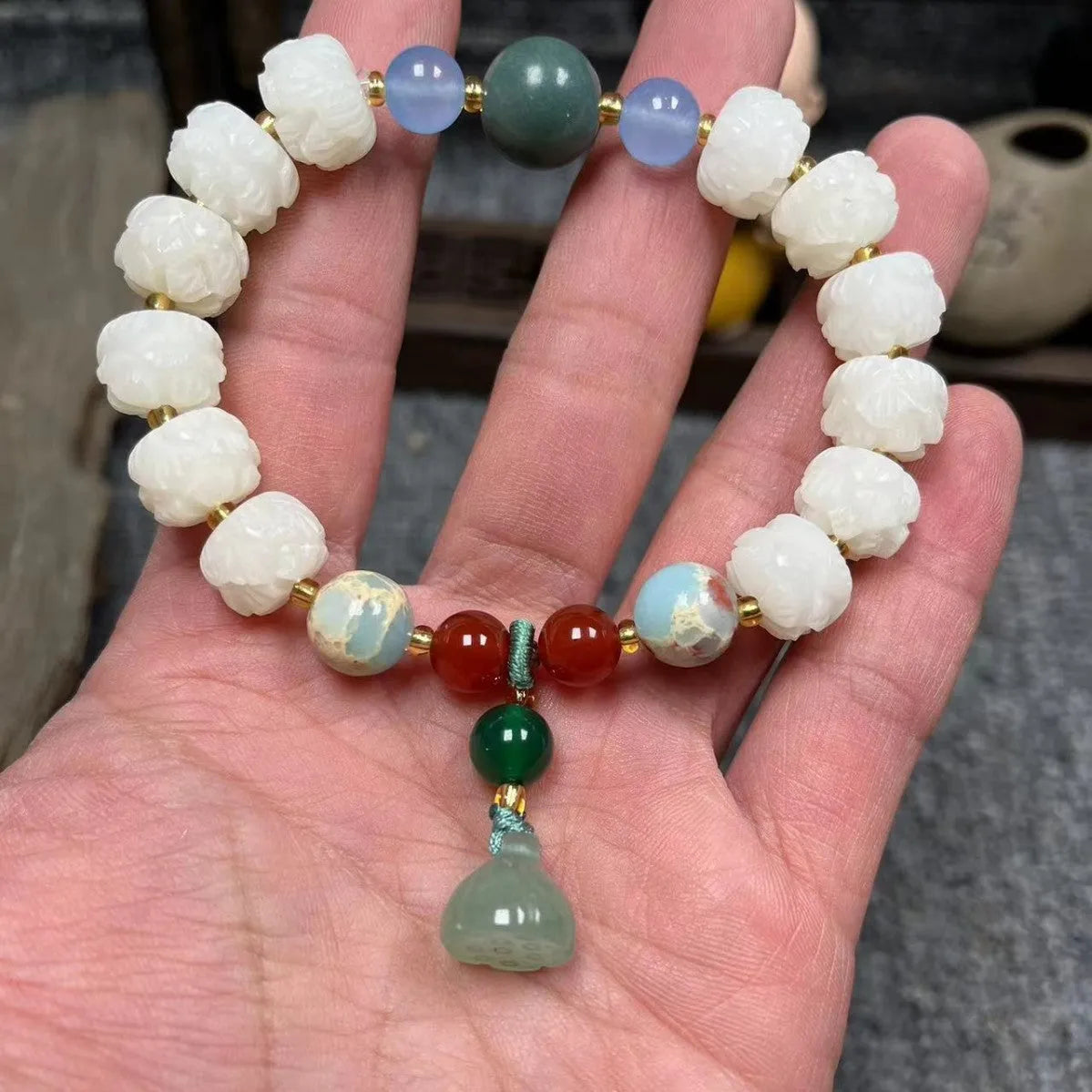 Carved pumpkin and lotus bead bracelet made from Bodhi root with white jade and aventurine details.
