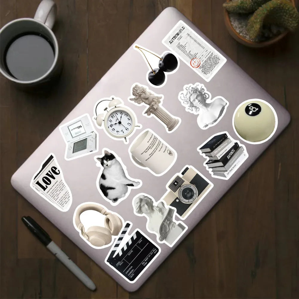 Assortment of 61 black and white waterproof PVC stickers for laptops, phones, and travel gear.