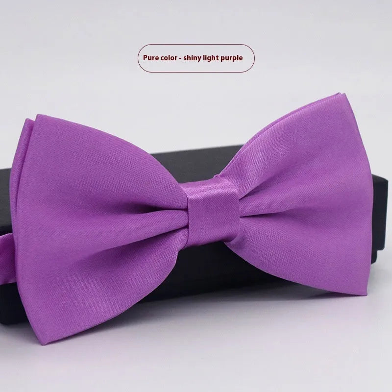 Men's flat head style polyester bow tie in a solid colour, shown with adjustable neck strap.