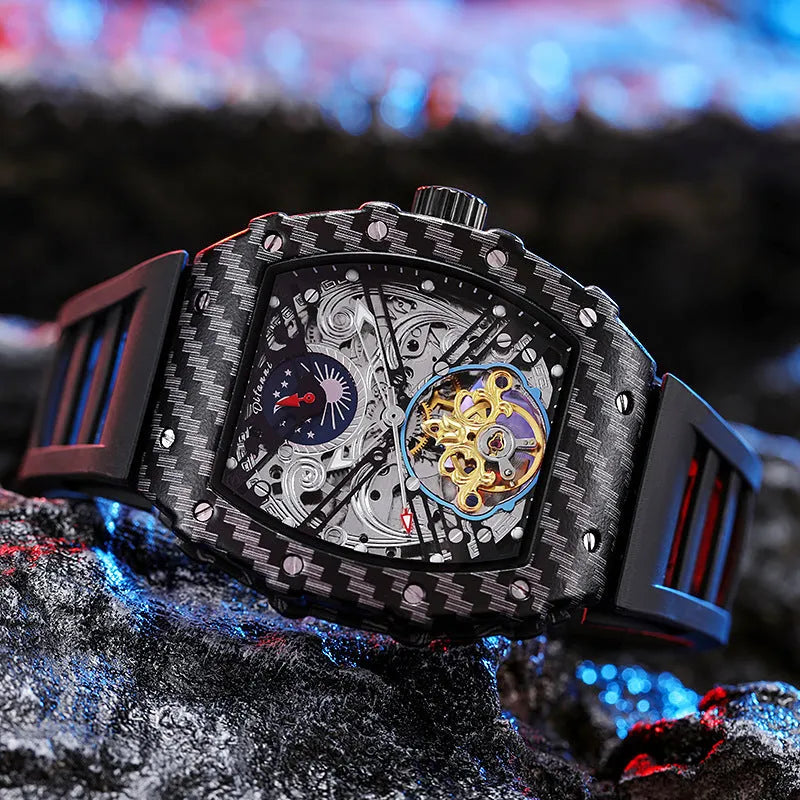 Men's mechanical watch with luminous hands on a rubber strap, showing a black dial with light blue inner shadow and a stainless steel buckle.