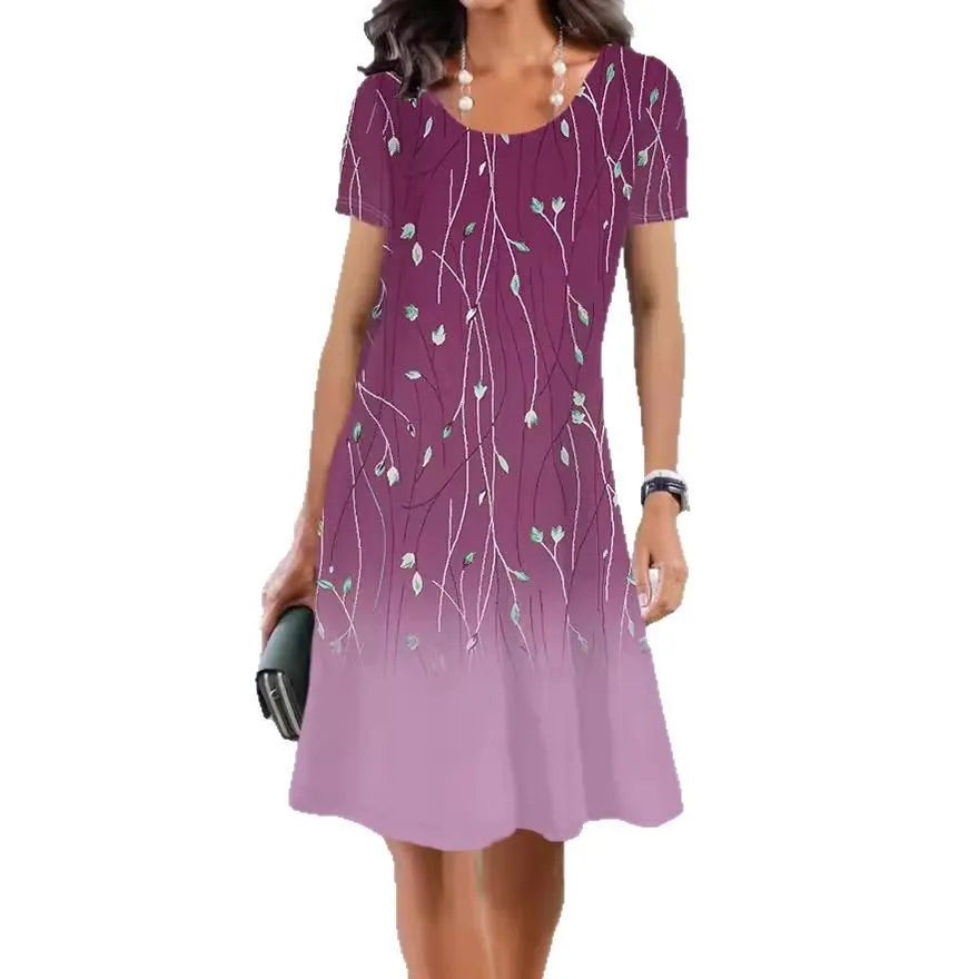 A model wearing a light blue botanical print midi dress with short sleeves and an A-line skirt.