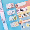Roll of colourful cartoon name tape stickers showing Dinosaur, Astronaut, Rabbit, and Girl design options.