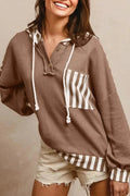 Straw yellow hoodie with waffle texture and striped patchwork design, featuring a button neck and drawstring hood.