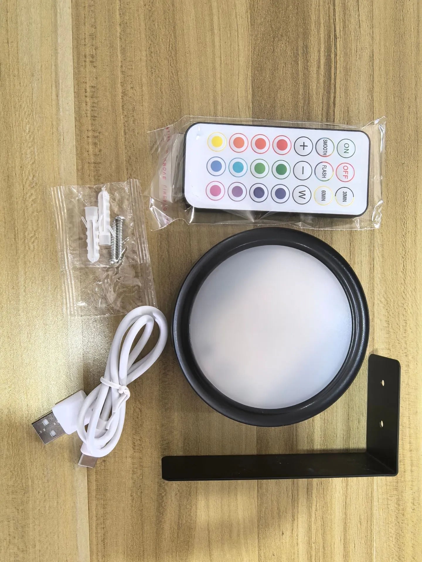 Wireless rechargeable LED painting lamp with magnetic belt attached to a metal frame, remote control nearby.