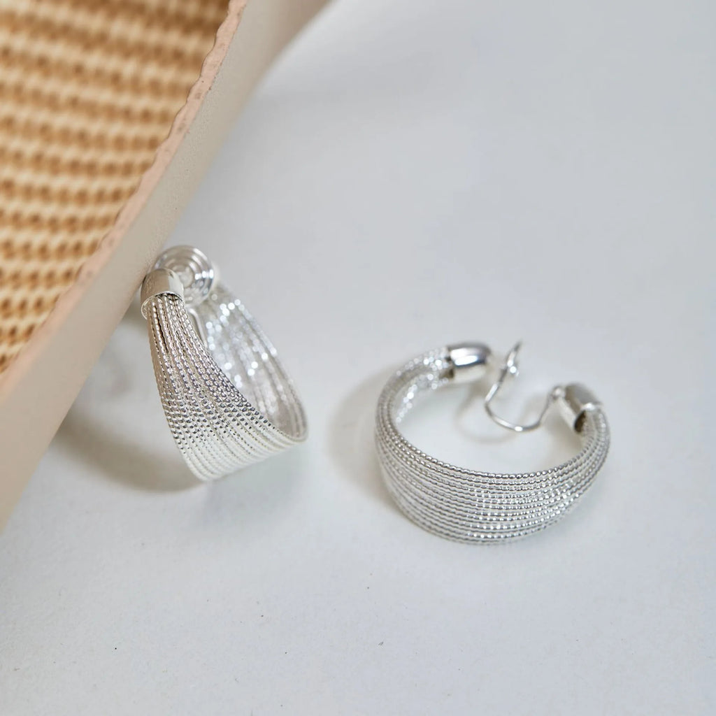 Geometric copper stud and clip earrings in gold and silver electroplated colours with simple multi-layer design