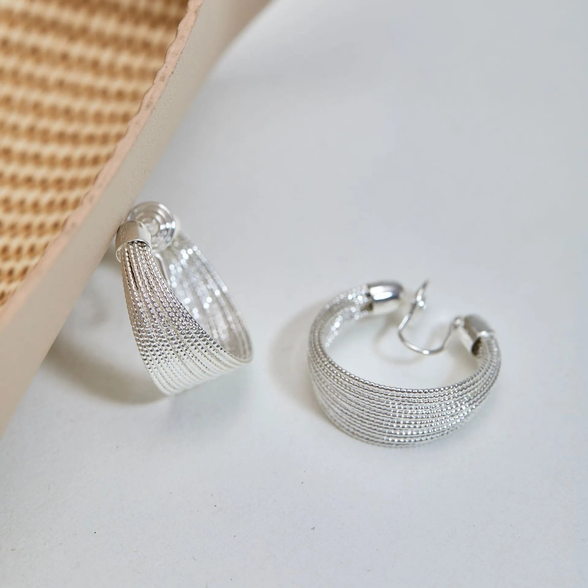 Geometric copper stud and clip earrings in gold and silver electroplated colours with simple multi-layer design