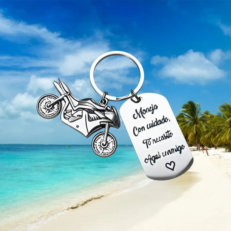Stainless steel metal keychain on a velvet cloth, showing Motorcycle Keychain and Flannel Bag style options.