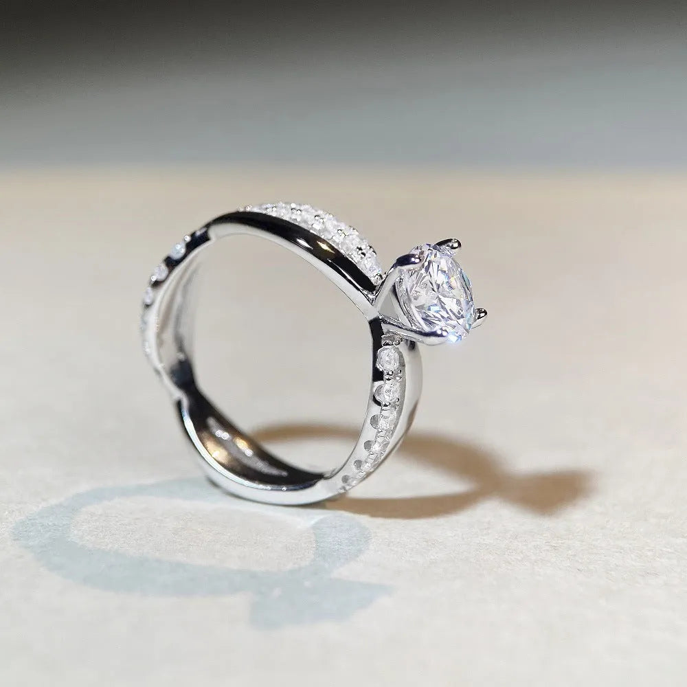 Geometric twisted arm silver ring with 1 karat moissanite centre stone in four-claw setting