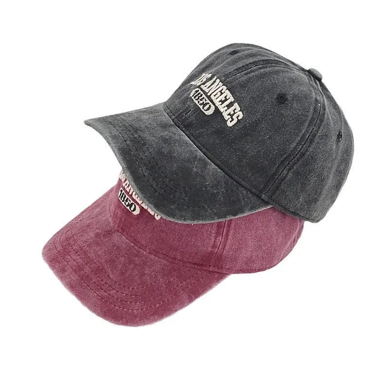 Retro personalised distressed embroidered peaked cap in beige colour with adjustable strap and conical crown.