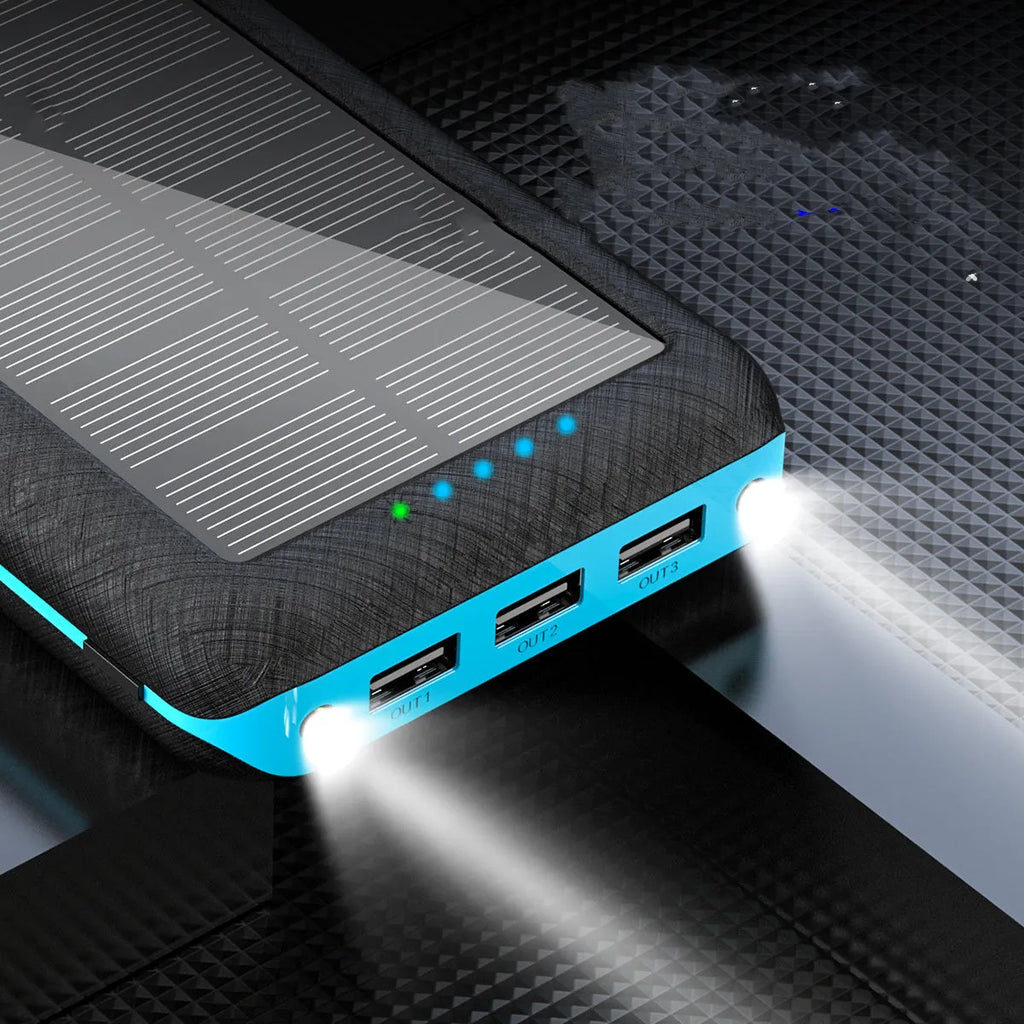 Portable power bank with wireless charging pad and three USB ports in black plastic casing