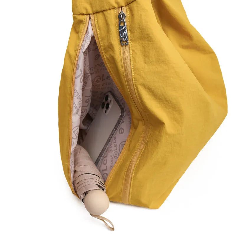 Nylon underarm bag with heart shape design in four colour options showing large capacity interior
