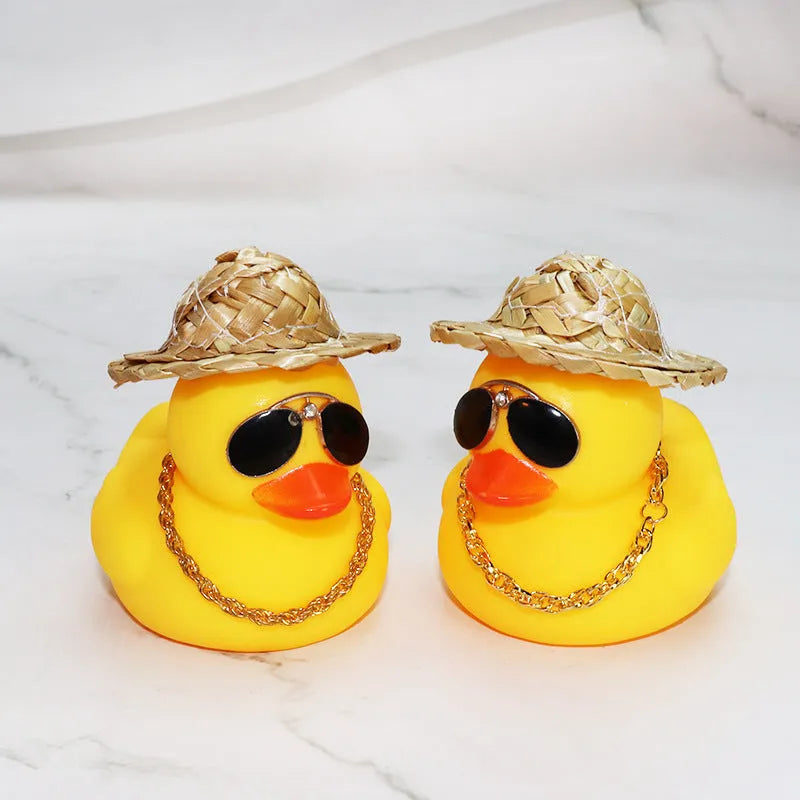 Yellow cartoon Straw Hat Duck car dashboard ornament with matte finish on a car interior.