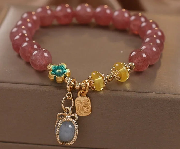 Red strawberry quartz beaded bracelet with alloy metal and rhinestone details