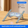 Silver aluminium laptop stand with dual cooling fans in folded position on desk