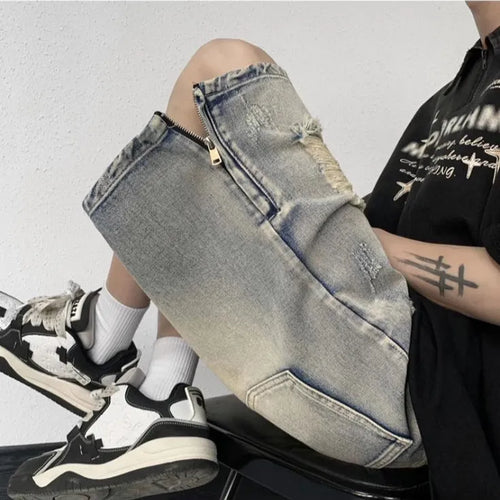 Blue retro tattered denim shorts with a wide leg and loose fit on a hanger.