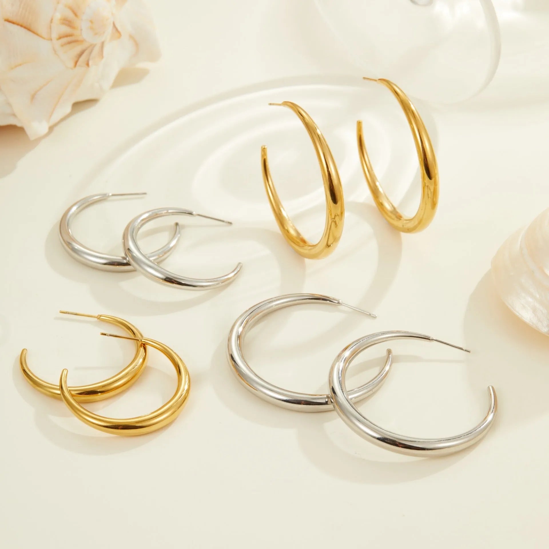 Women's stainless steel hoop earrings with 18K PVD gold plating in geometric round design