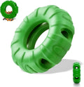 Blue rubber tire-shaped dog chew toy with oval openings for treat dispensing on a white background.
