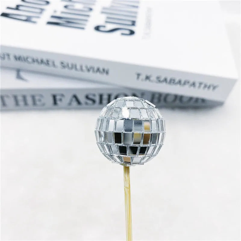 Glass mirror ball cake decoration on a wooden stick in various sizes for birthday and party cakes.