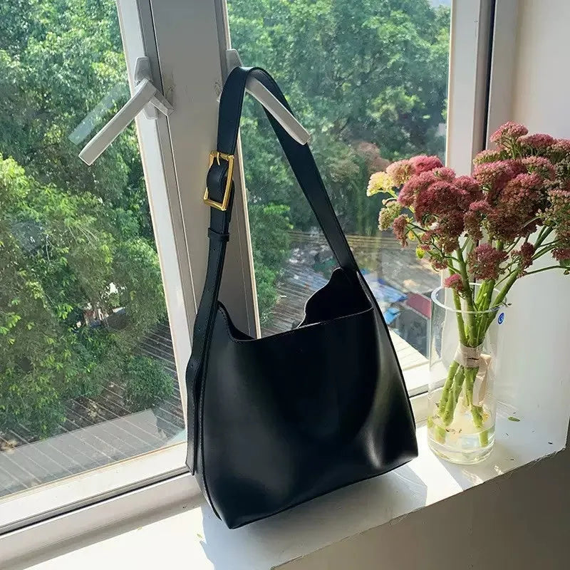 Women's black and brown shoulder bags with swinging threads and soft PU leather construction