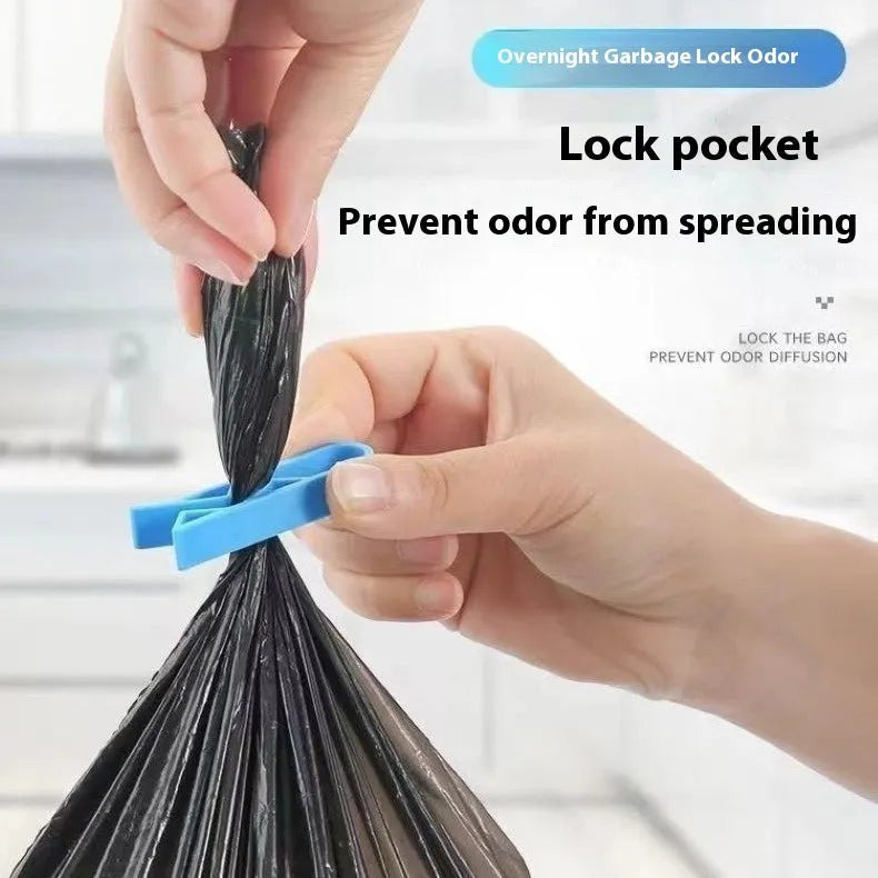 White PP plastic non-slip clip holding a black bin liner to the side of a silver kitchen trash can.