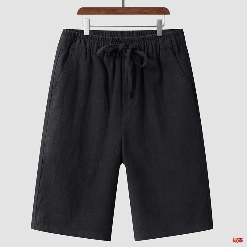 Men's beige linen casual shorts with a loose fit and cropped length on a plain background.