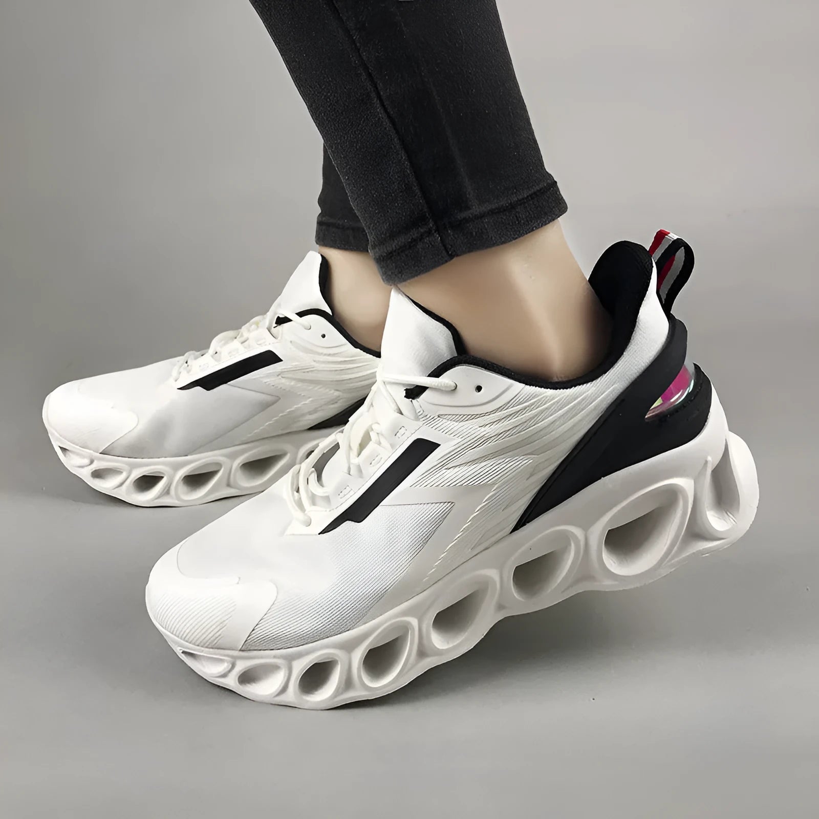 Low top casual shoes in black, white, and dark blue with mesh upper and lace-up front.