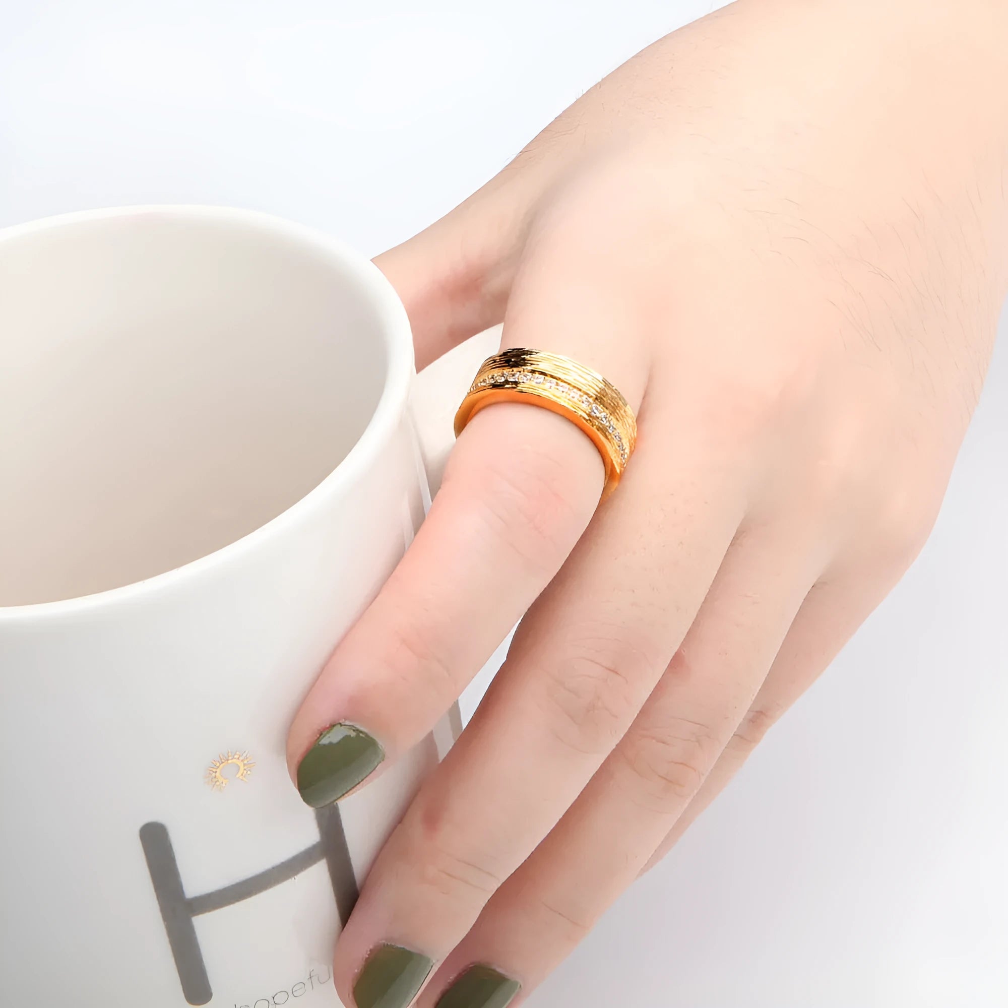Gold colour geometric women's ring with a zircon stone on a copper band.