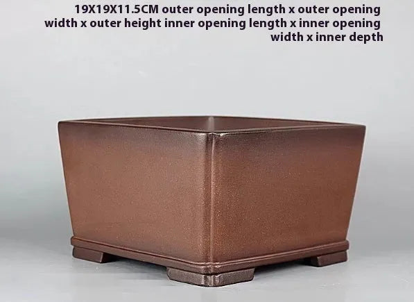 Brown handmade purple clay antique flower pot with drainage hole.
