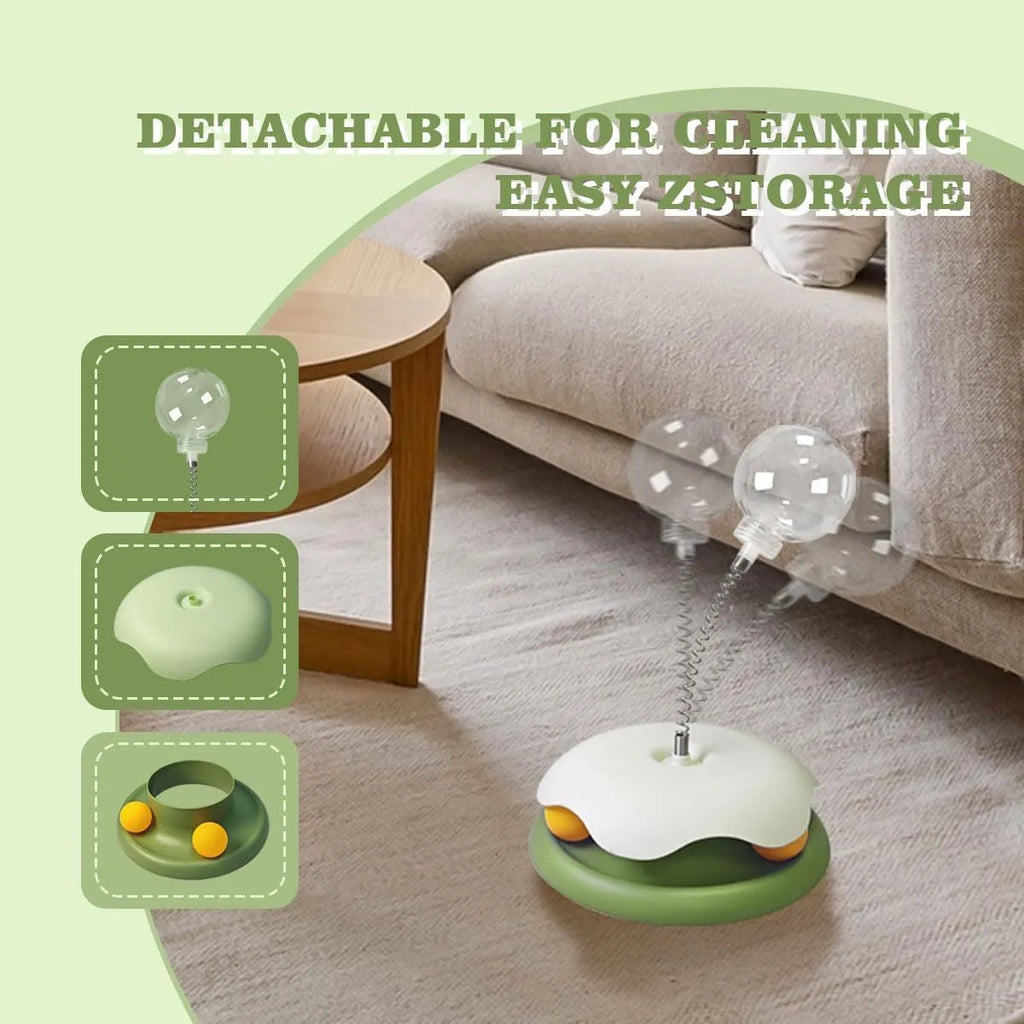 Blue or green PP plastic cat treat dispenser toy with a built-in track ball on a flat surface.