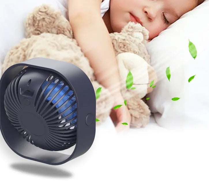 USB desk fan with rotating head in modern alarm clock design on desk