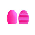 Silicone makeup brush wash egg in blue with top knobs and bottom grooves for cleaning bristles