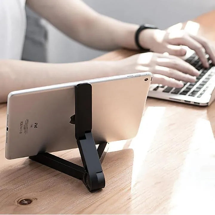 Black foldable aluminium tablet holder open in landscape mode supporting an iPad, showing side adjustment buttons.