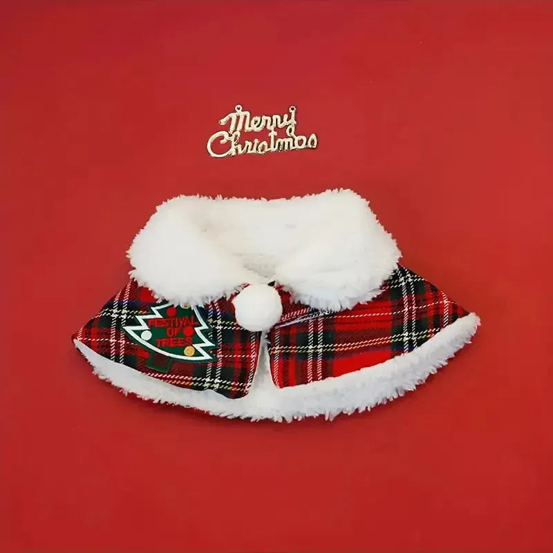 Pet wearing red Christmas cloak with bell design, draped over back with festive snowflake pattern