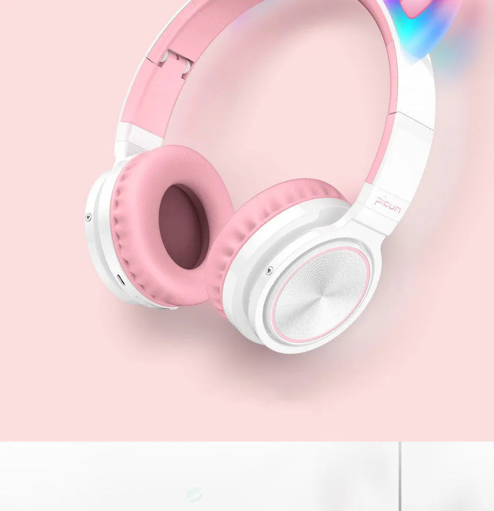 Pink white Luminous over-ear Bluetooth headset with braided wire and large ear cushions.