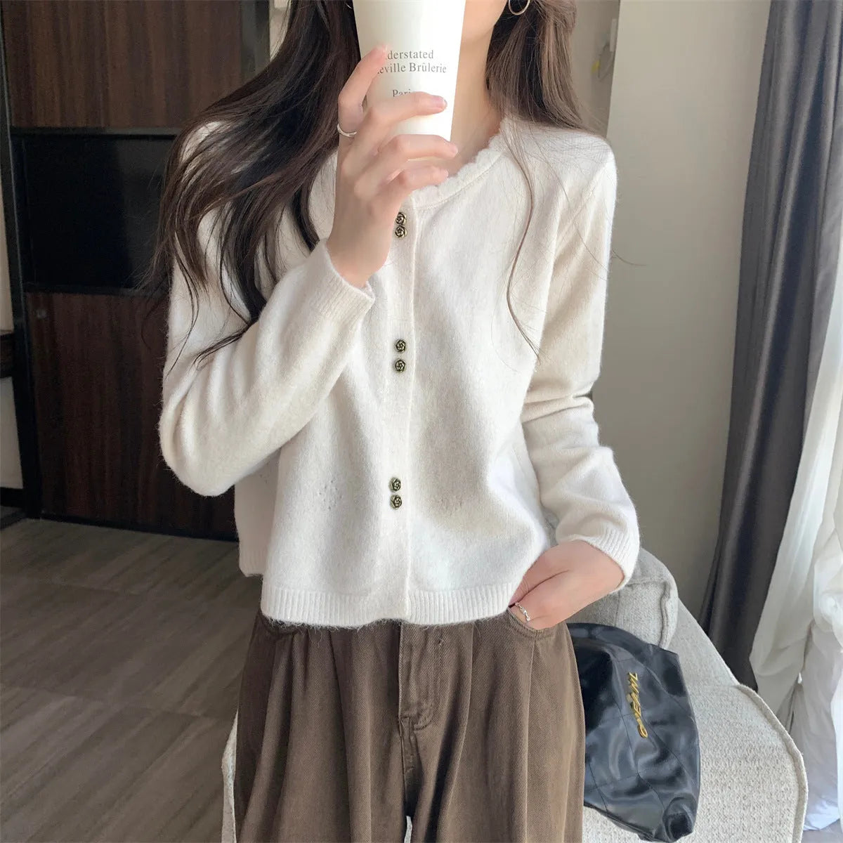 Women's milky white acrylic long-sleeve cardigan coat worn open, free size regular fit.
