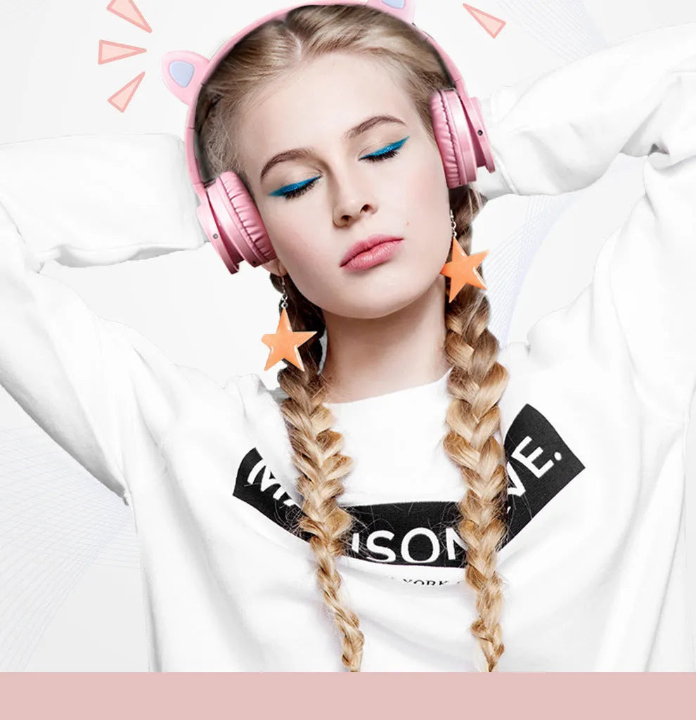Pink white Luminous over-ear Bluetooth headset with braided wire and large ear cushions.