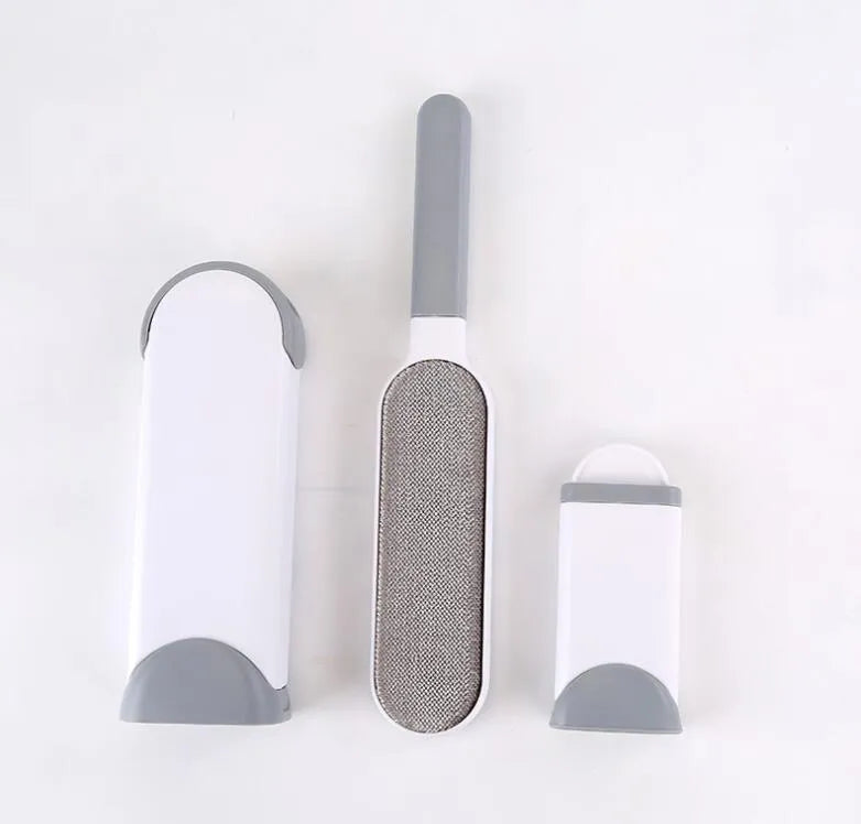 Blue reusable pet hair removal brush with a self-cleaning base, placed on a grey sofa.