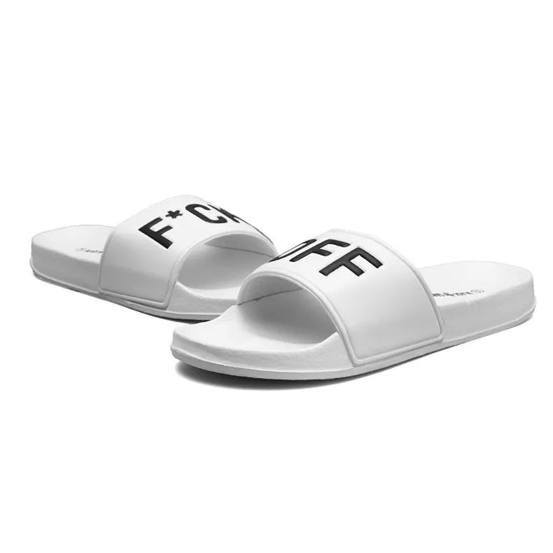 Men's black and white open-toe slippers with a textured rubber sole on a plain background