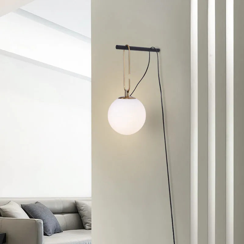 Modern Nordic glass wall lamp with three light colour options on a contemporary wall
