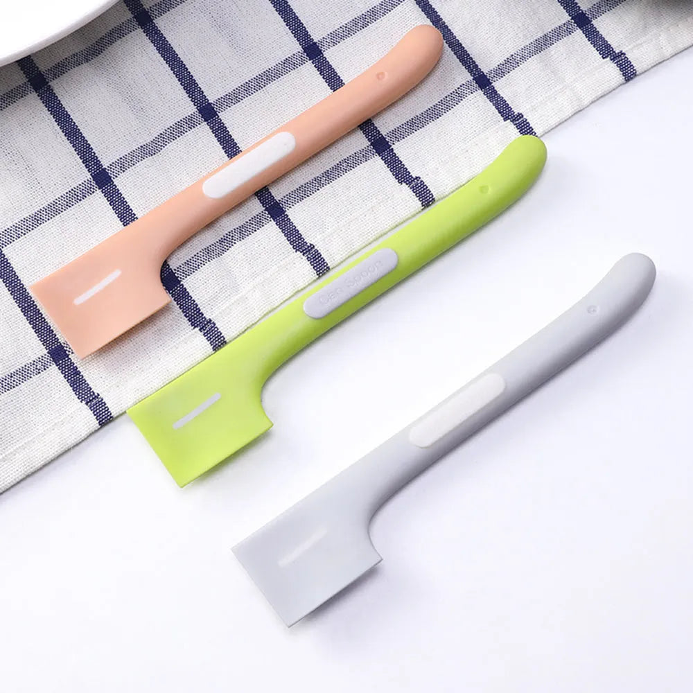 Long green TPR pet food spoon with right-angle head for feeding from tins