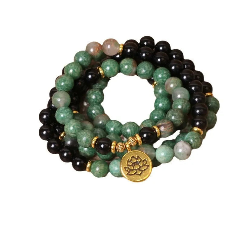 Women's green and black alloy elastic beaded bracelet on a wrist, showing natural style design.